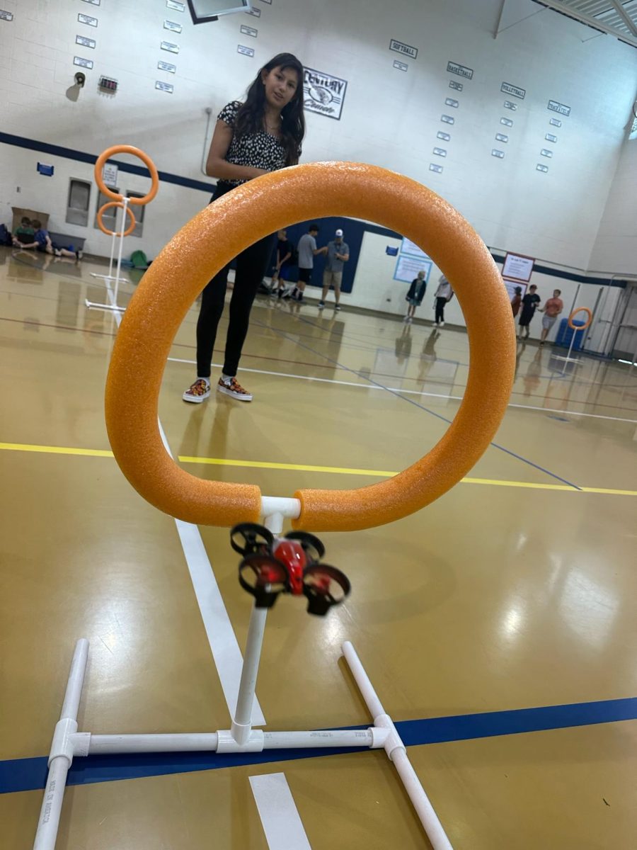 Janessa Woods practices flying drones in the gym at aviation club. 