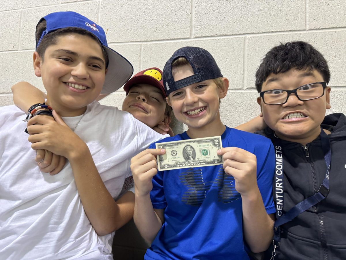 Seventh graders Eli Martinez, Max Theime, Rylan Lafave, and William Bik show their excitement over Rylan winning a $2 bill. 