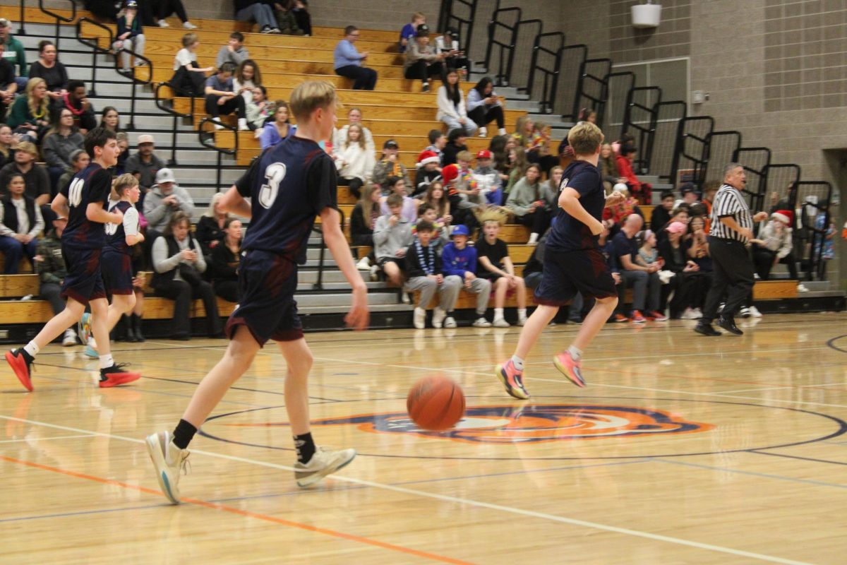 8th grade boys play basketball.